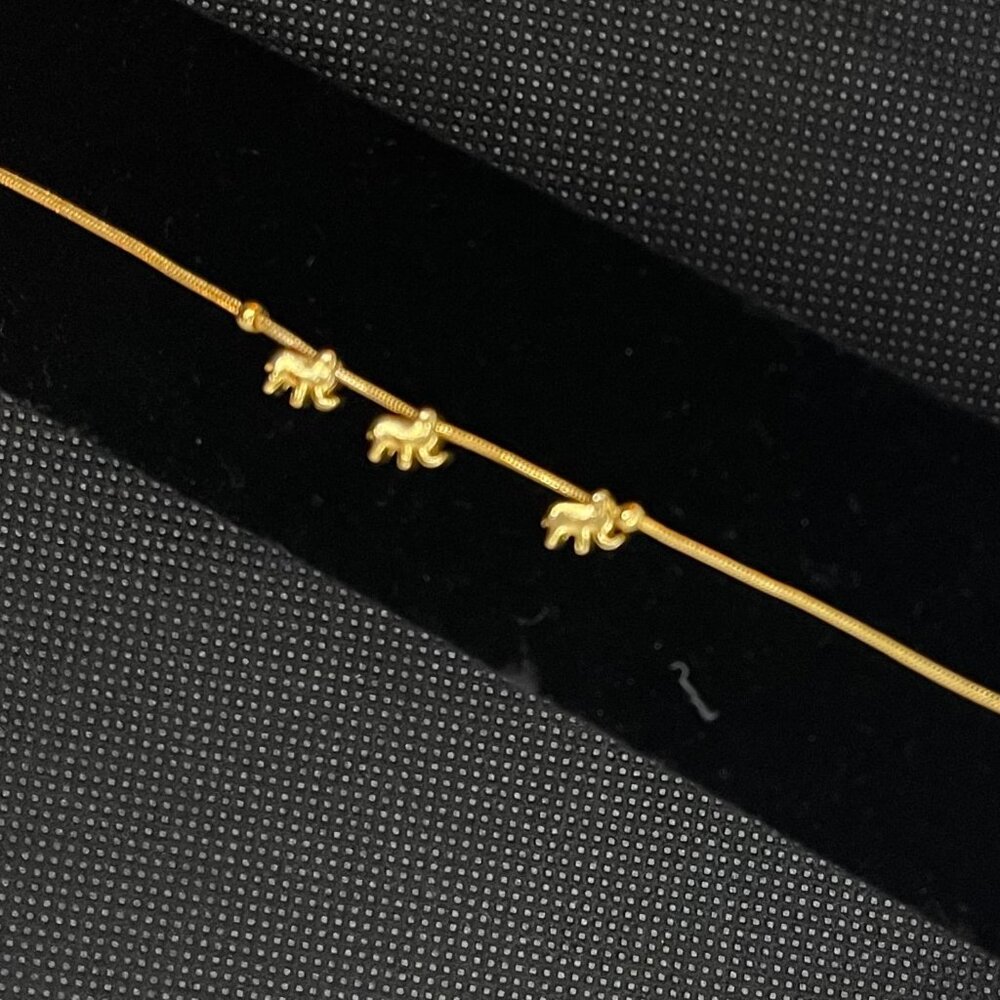 Gold tone 7" bracelet with three elephant charms. Absolutely charming!